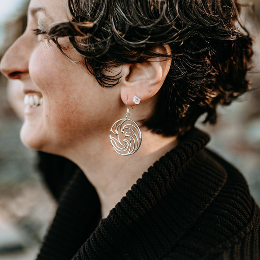 model wearing raw Herkimer diamond stud earrings stacked  with silver ocean curl earrings