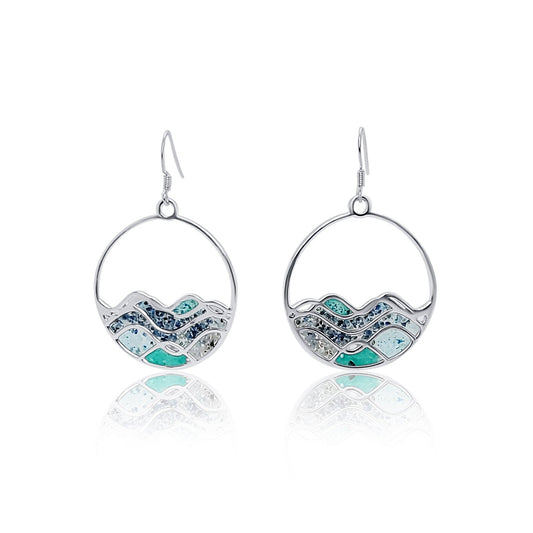 front of High Tide Blue Ocean Wave Circle Earrings with resin, saphores, mica, turqoise and malachite