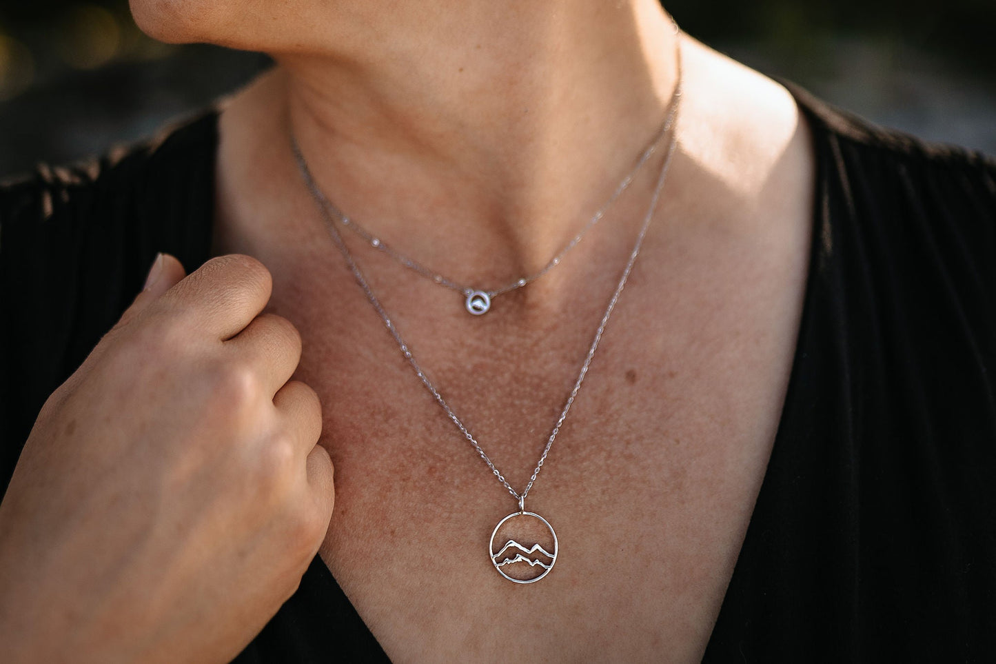 yellow gold little coast mountain circle pendant necklace on white jewelry card