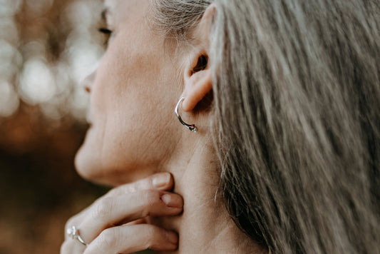 side view of model wearing Margot freshwater pearl silver half hoop stud earrings