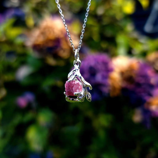 one of a kind silver pendant necklace featuring raw natural pink tourmaline with silver leaf setting