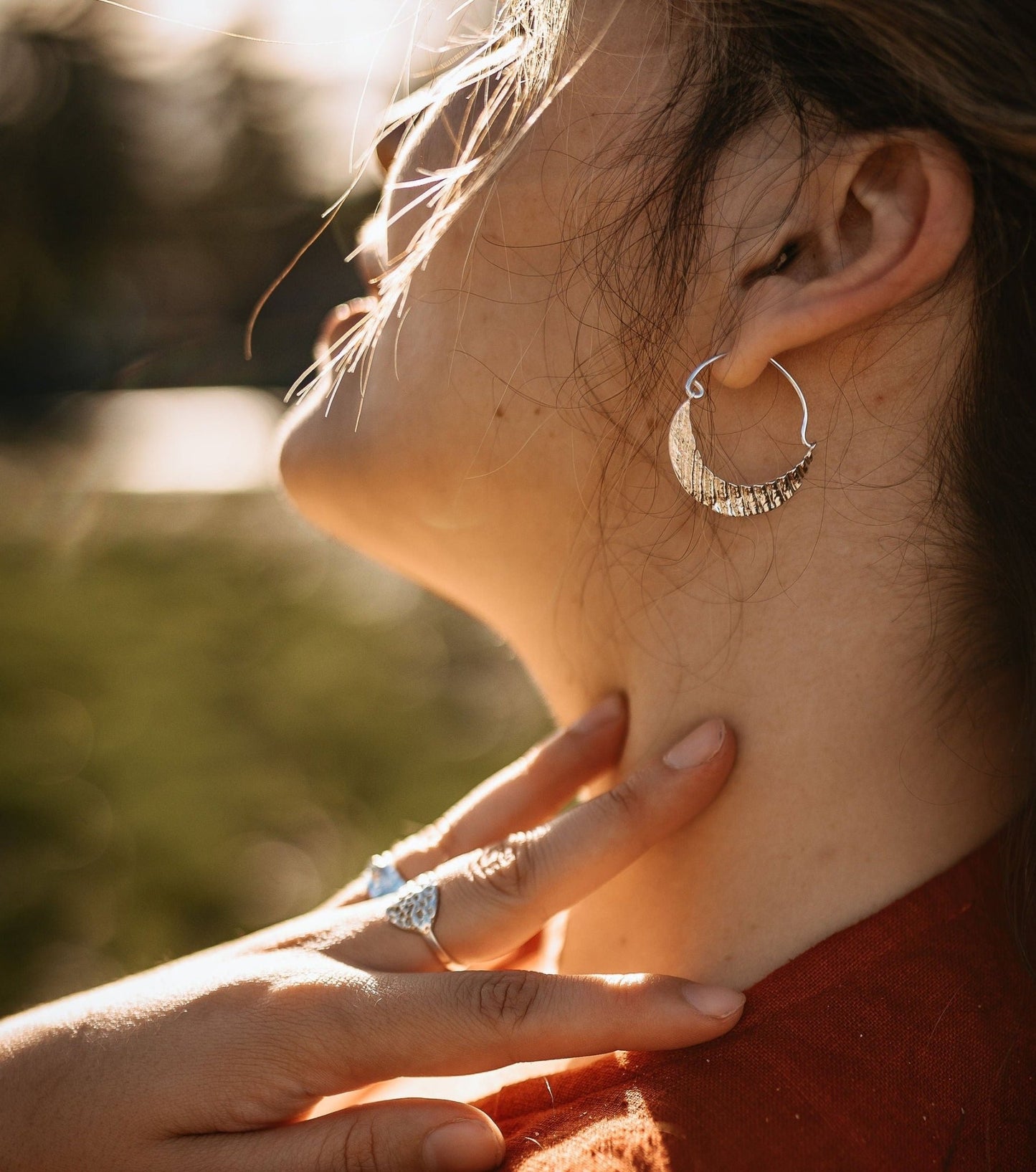seashell textured silver crescent moon hoop earrings - front view