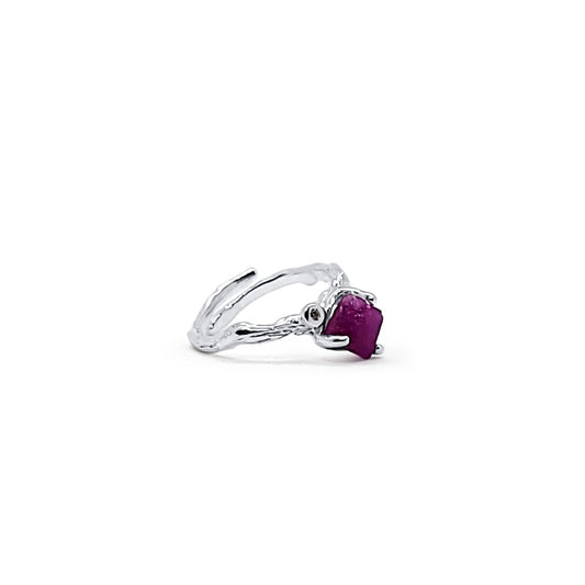 Side view of a one-of-a-kind, handmade, adjustable silver ring with branch design, featuring raw ruby and zircon.