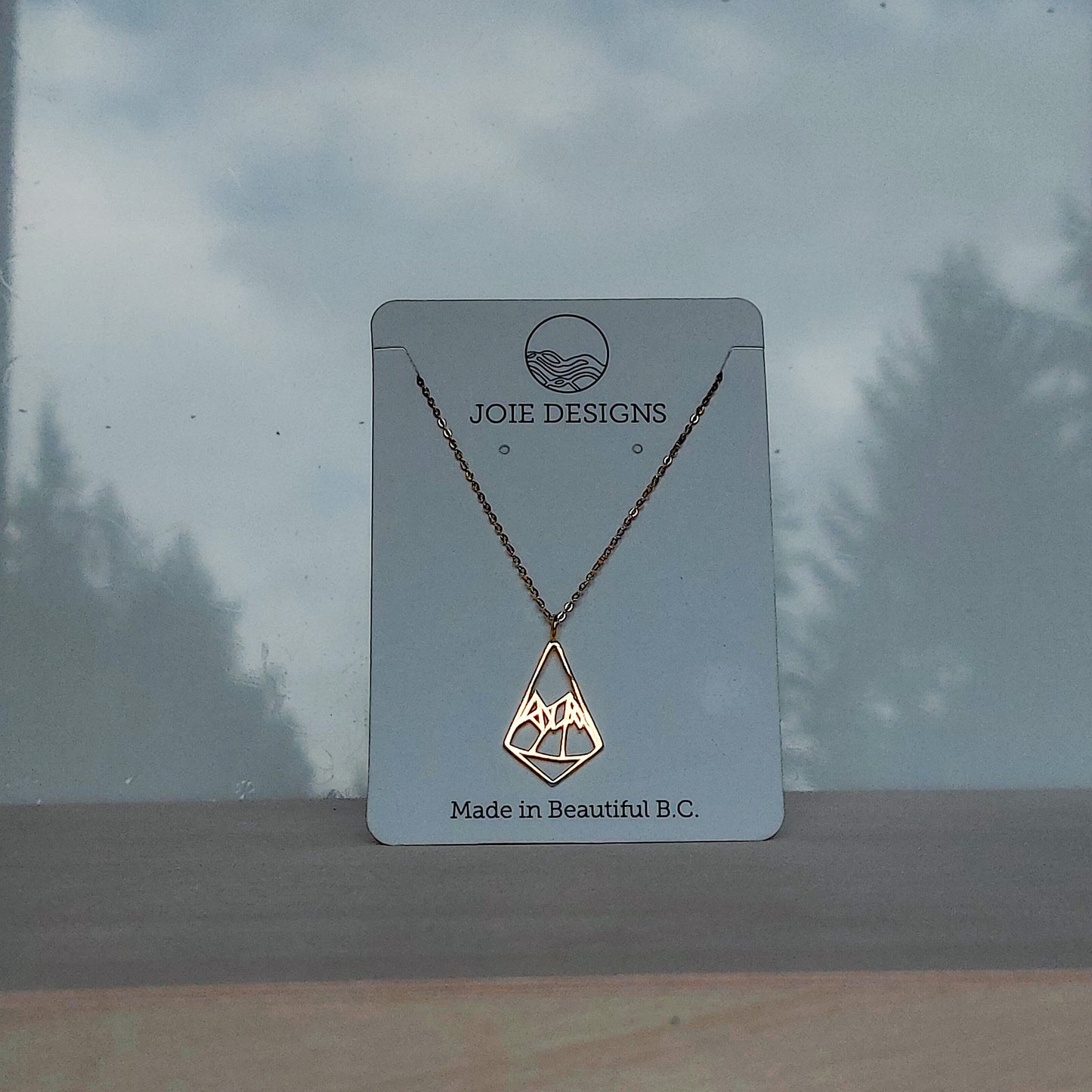 18k gold plated sterlinng silver geometric mountain pendant necklace on a Jewelry card