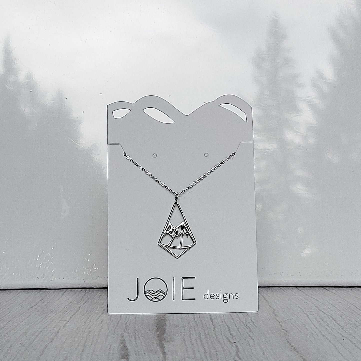 925 sterling silver geometric diamond shaped mountain necklace on a Jewelry card