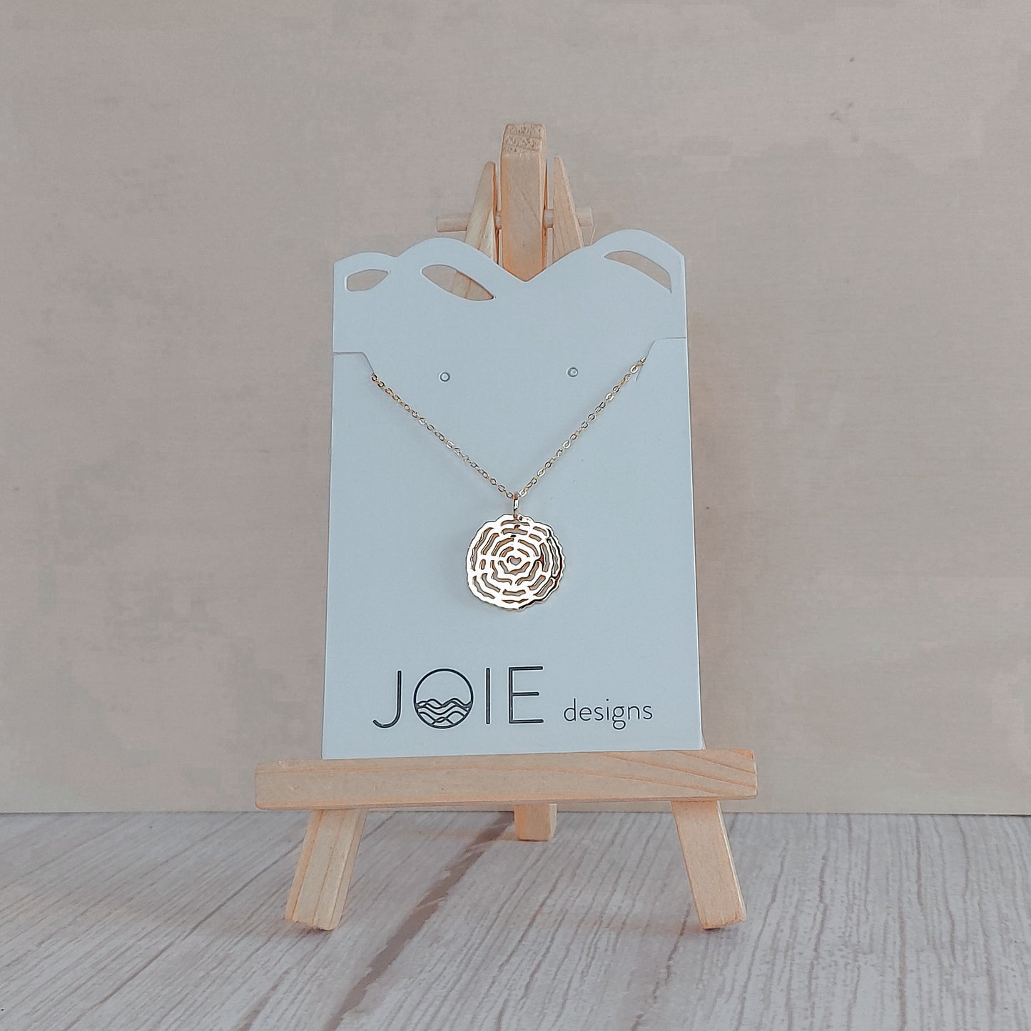 18k plated rose gold plated tree cross section that resembles a spiderweb