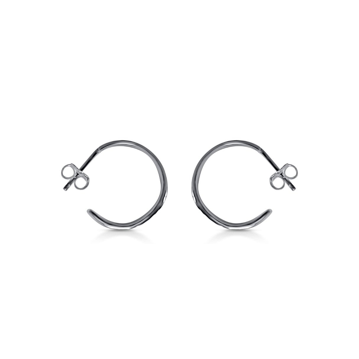 side view of organic wavy lightweight hoop earrings in tarnish resistant silver with natural wood texture