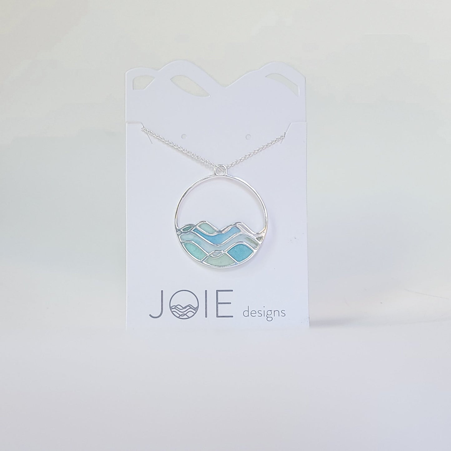 Embellsihed silver and resin blue limited edition high tide necklace side 1