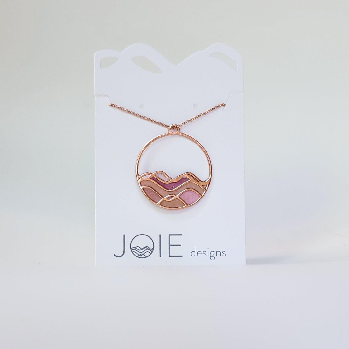 sunset colours on ocean waves rose gold pinks and golds circle necklace