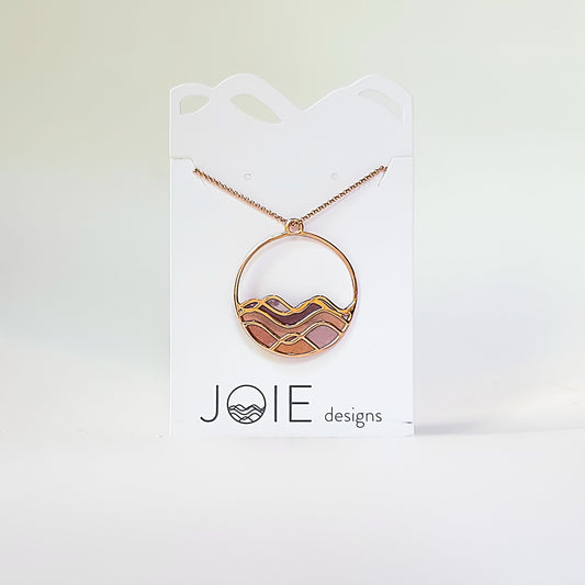 circle wave necklace with pinks, peach and gold tones in waves. sunset on water necklace