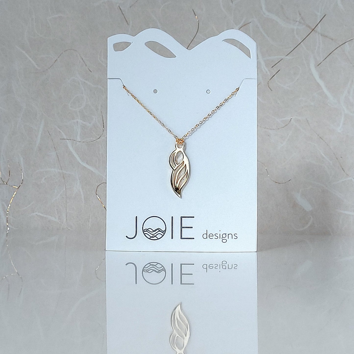 18k yellow gold plated wave pendant necklace showcased on a jewellery card