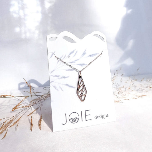 925 sterling silver Harla grass design pendant necklace showcased on a jewellery card with dried grass in background