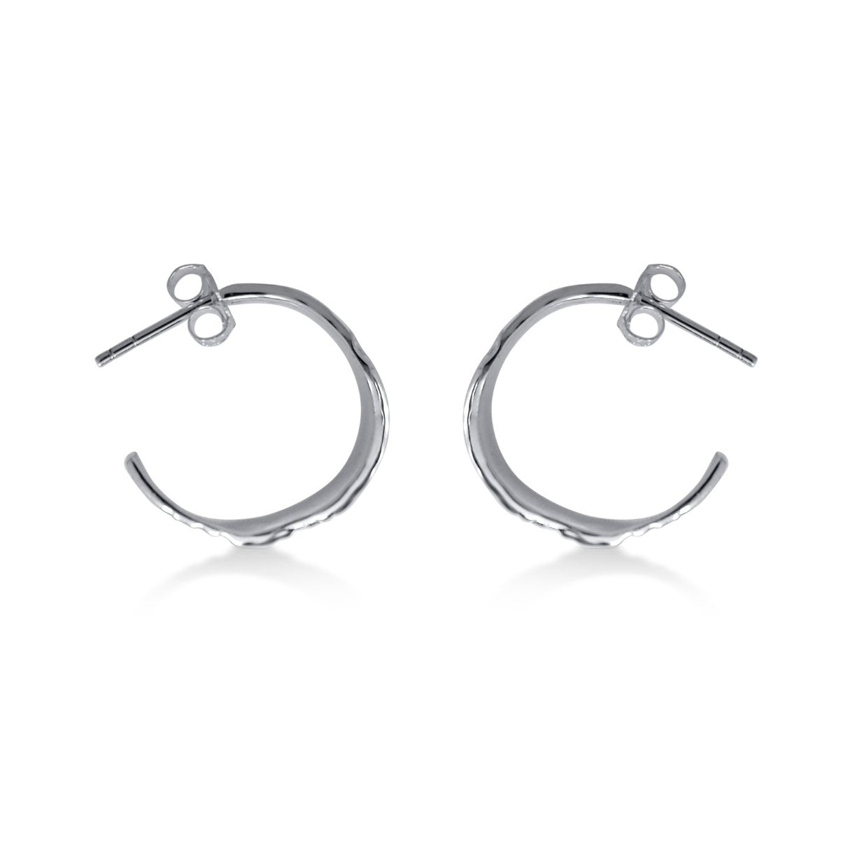side view of modern natural wood textured silver hoop earrings with posts