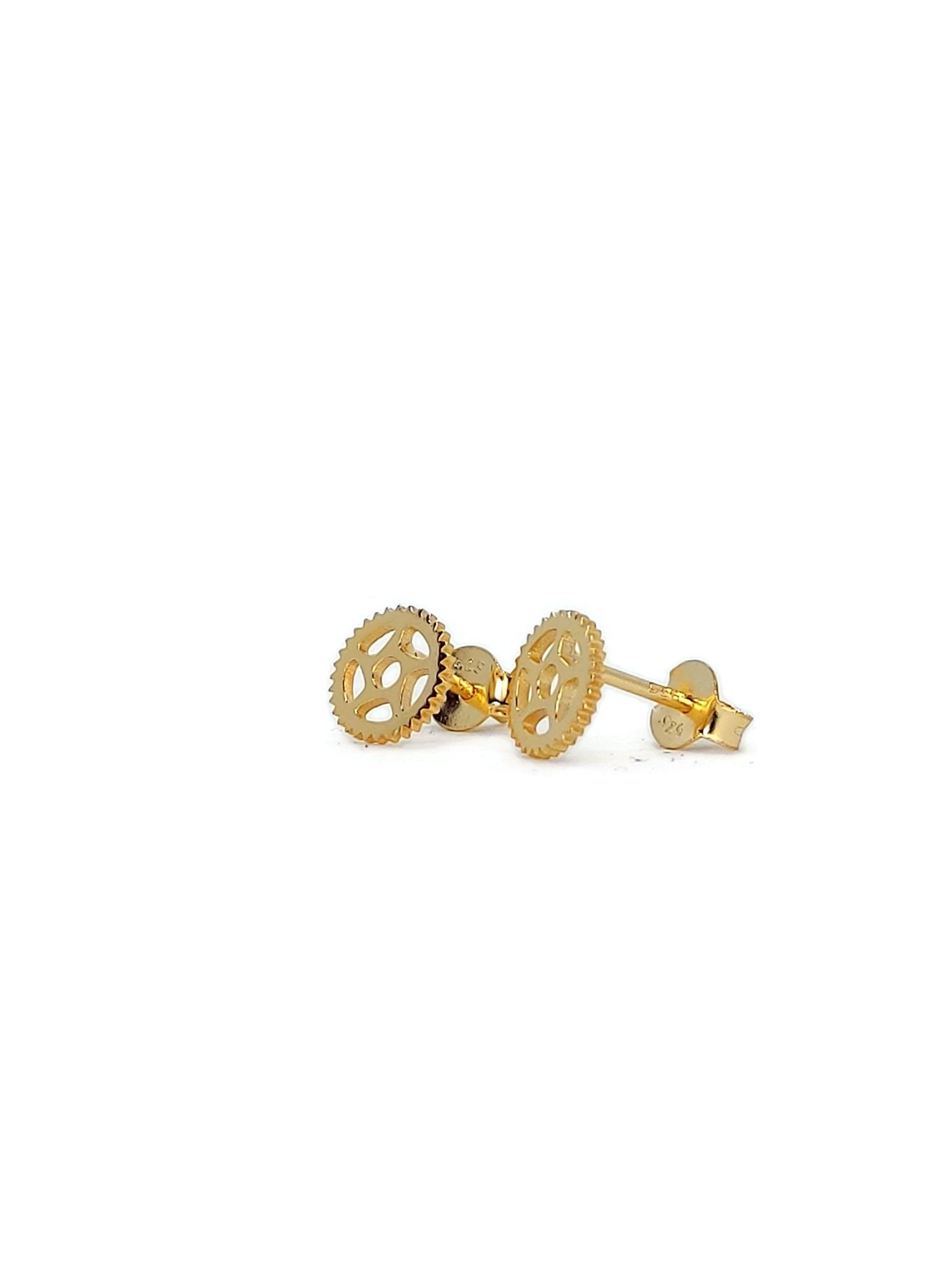 small bike gear post earrings in gold on white background