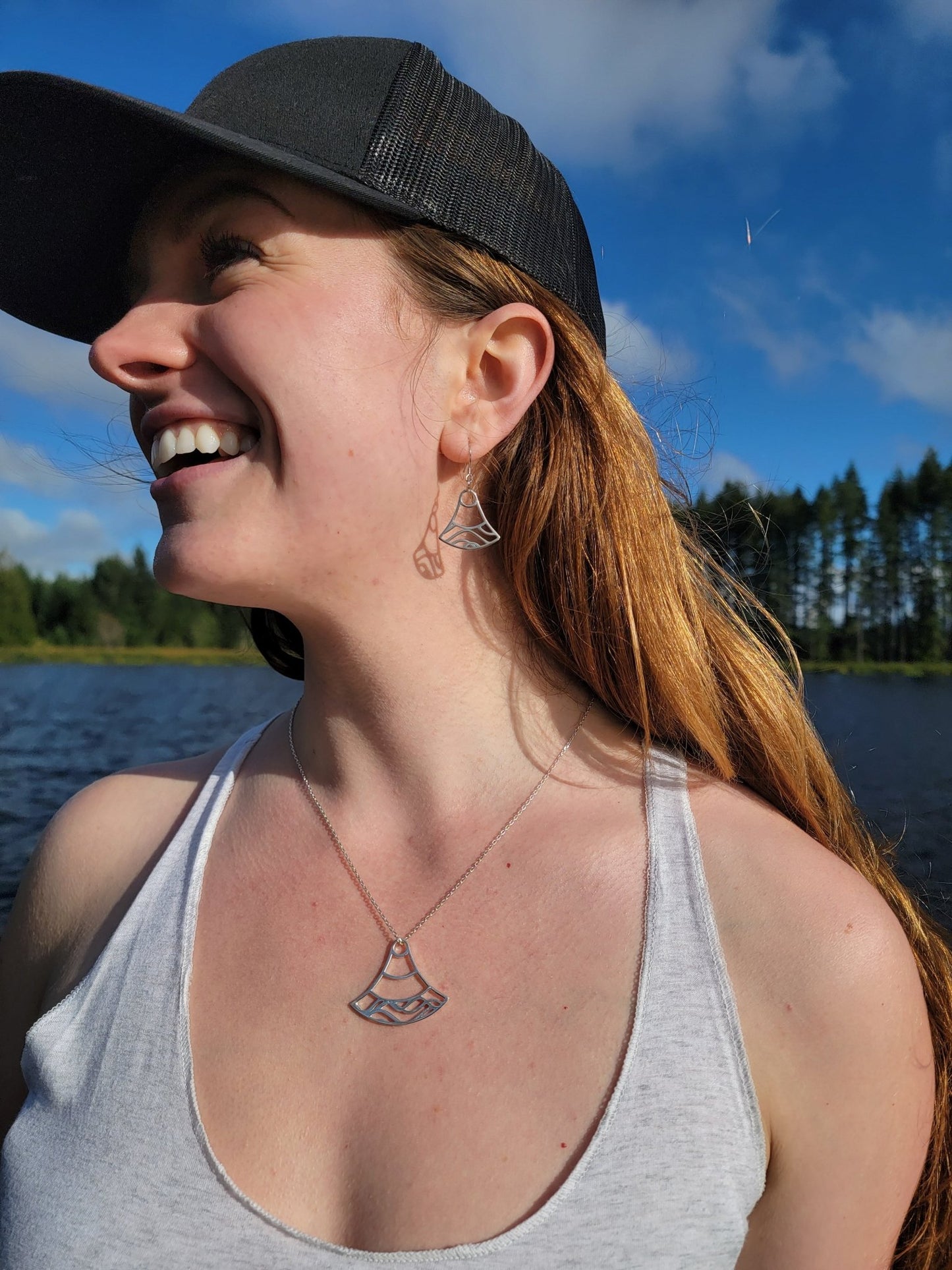 model at lake wearing sterling silver double wave ocean necklace and earrings 2