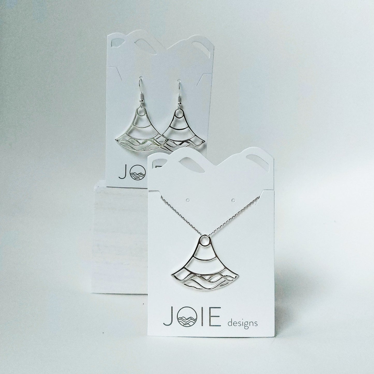925 sterling silver double water wave necklace on a white jewelry card with earrings