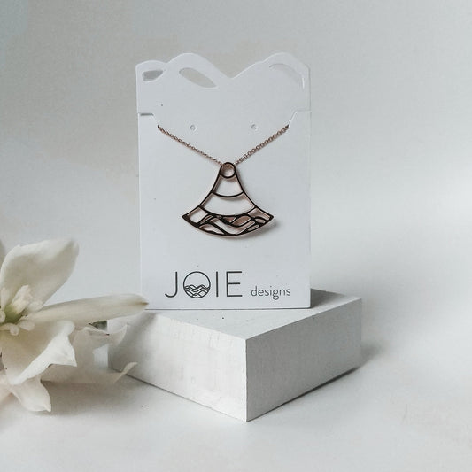 925 sterling silver double water wave Nalu design pendant necklace on a white jewelry card with flowers