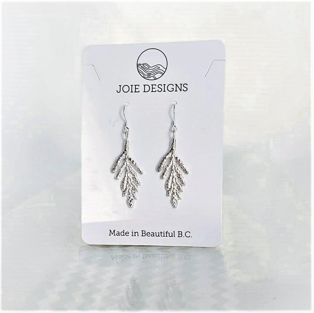 925 sterling silver cedar leaf design dangle earrings on a jewelry card