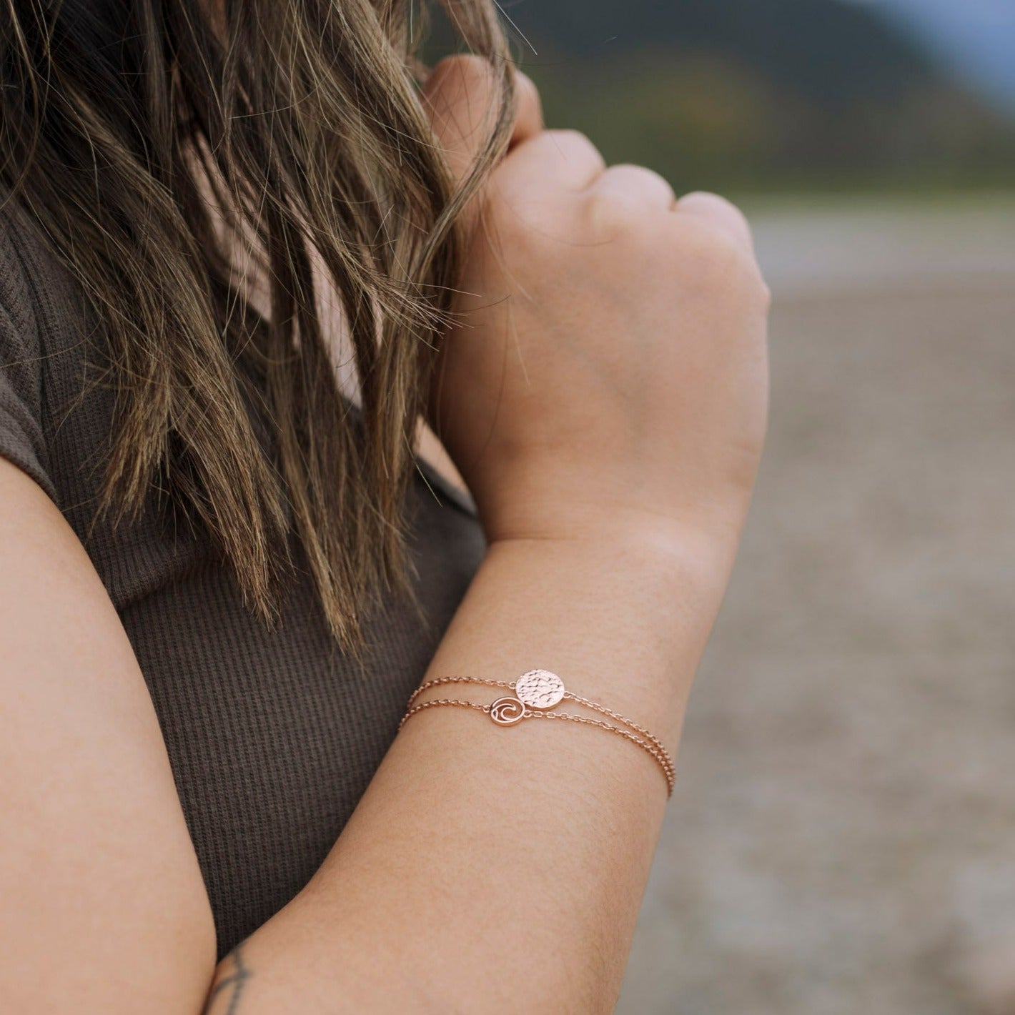model wearing rose gold plated Sol adjustable bracelet with textured circle charm closeup