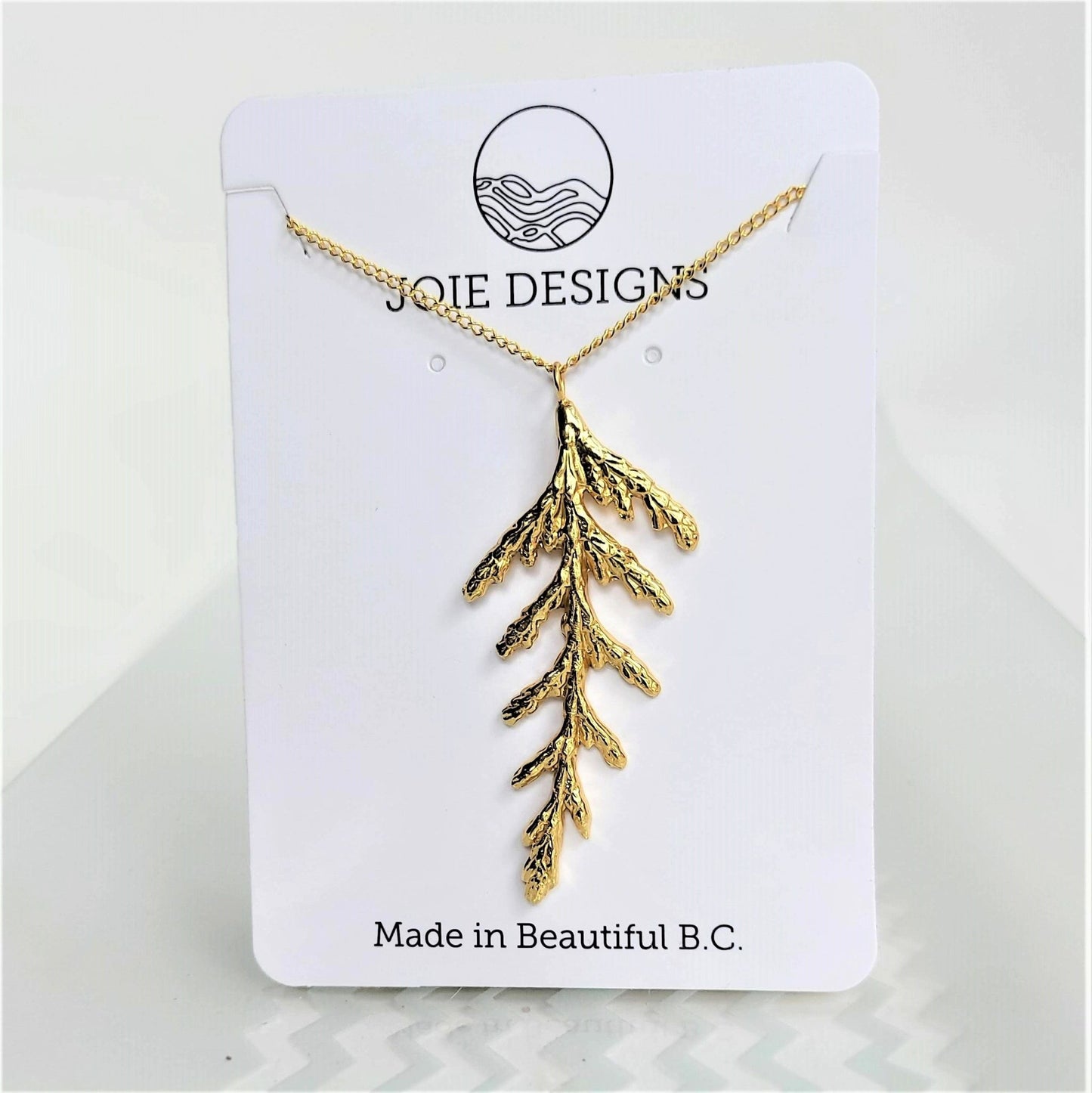 Nature-inspired cedar leaf necklace in silver with18k gold plating