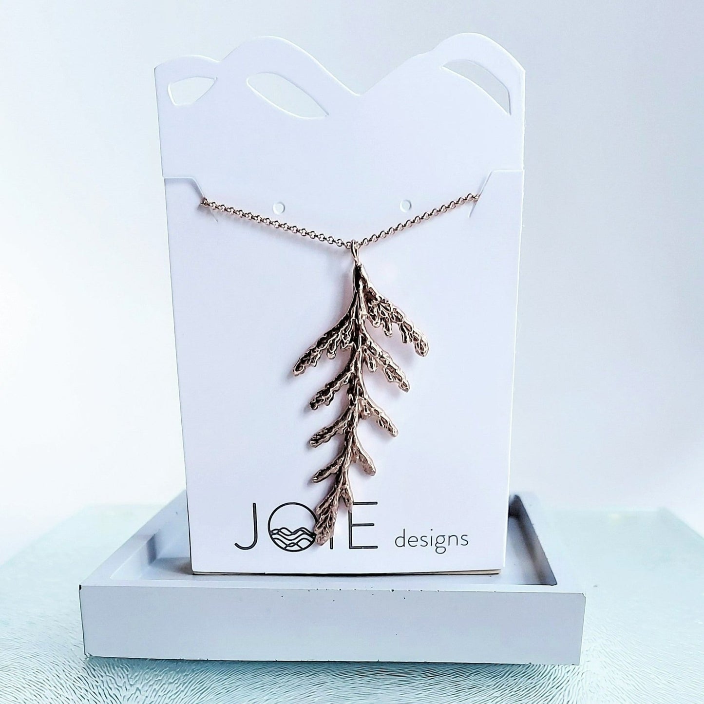 Nature-inspired cedar leaf necklace in 18k rose gold plating