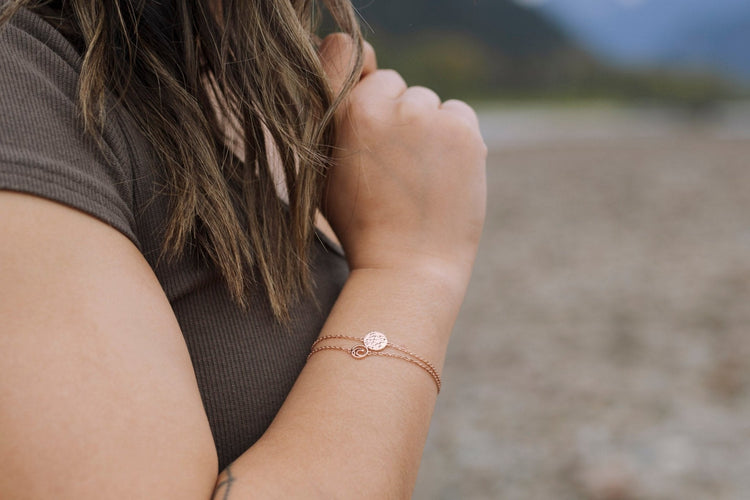 model wearing rose gold bracelet stack of Sol and Tofino ocean jewelry designs