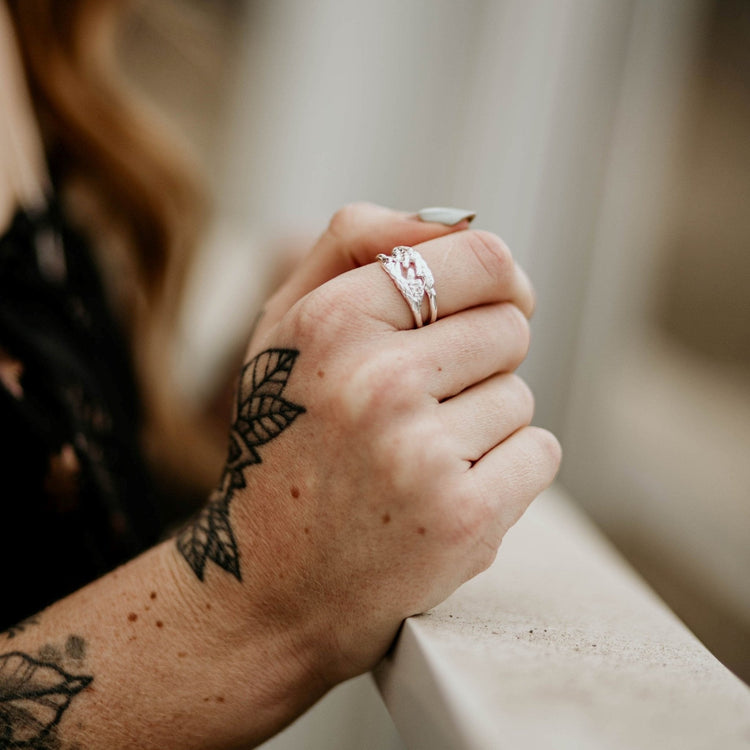 model wearing stack of sterling silver cedar leaf rings