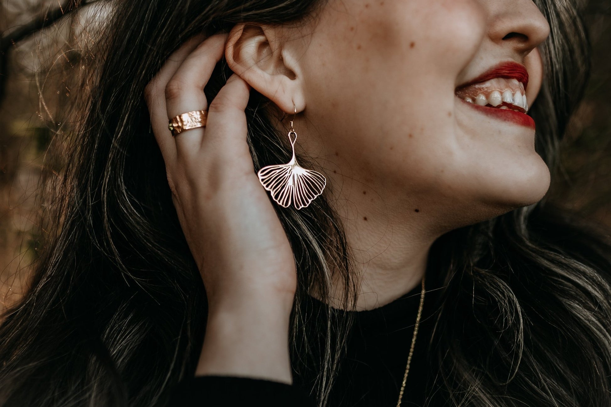 Model wearing in zoom side view - Adia Ginkgo Leaf Dangle Earrings