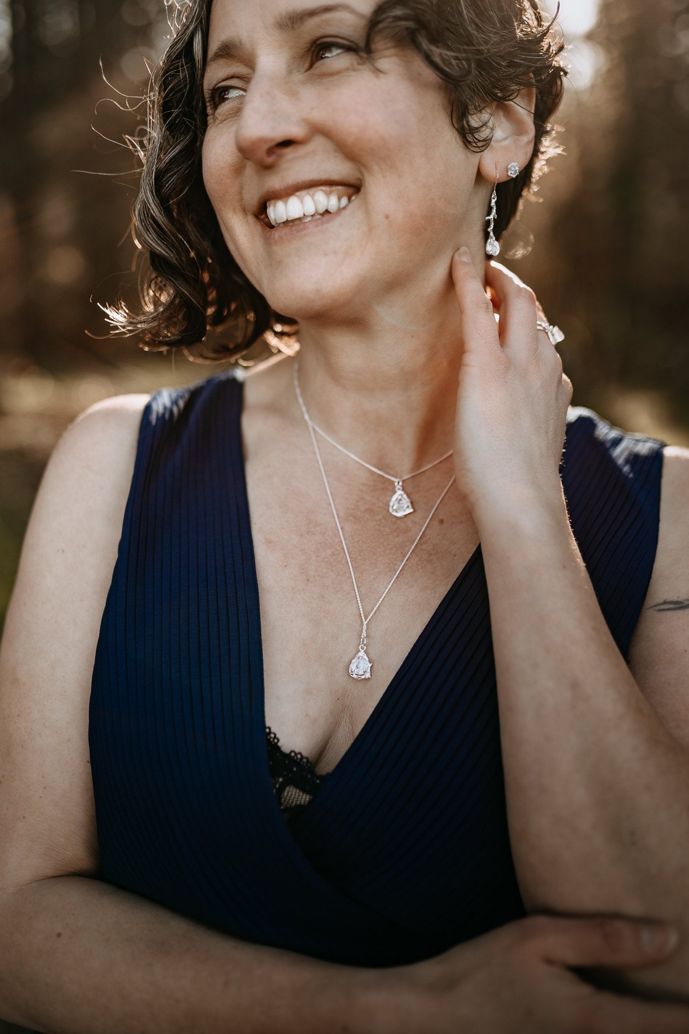 model wearing layered sterling silver and Herkimer diamond necklaces with matching dangle earrings, ring and stud earrings
