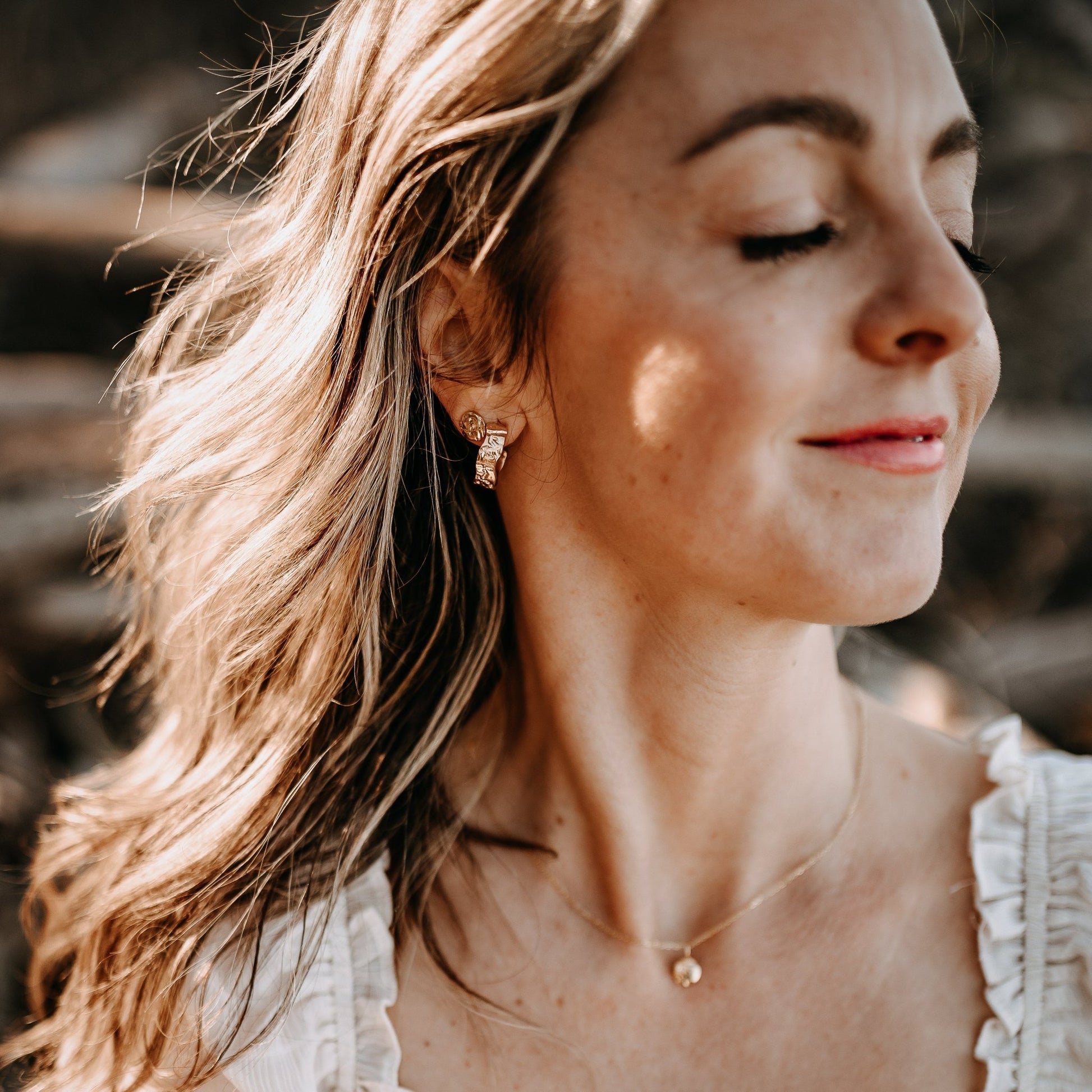 model wearing earring stacked jewelry of Ilana Hoops and Ayla Stud earrings in gold vermeil