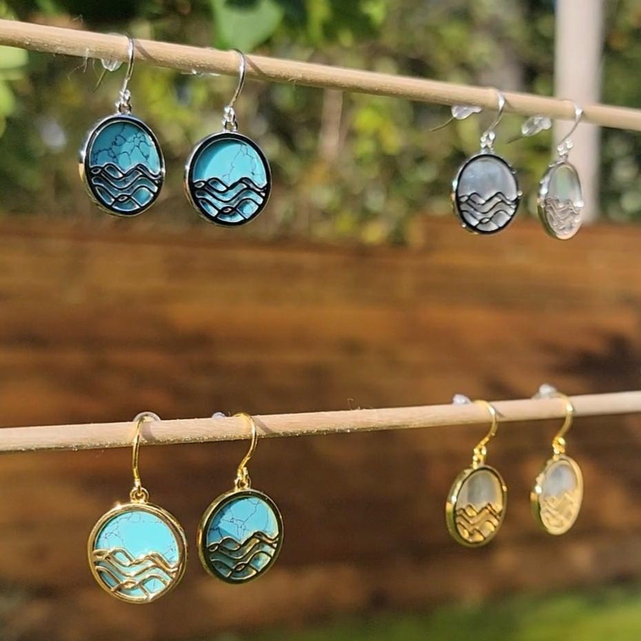 mother of pearl and turquoise circle dangle earrings. 4 sets on wood 