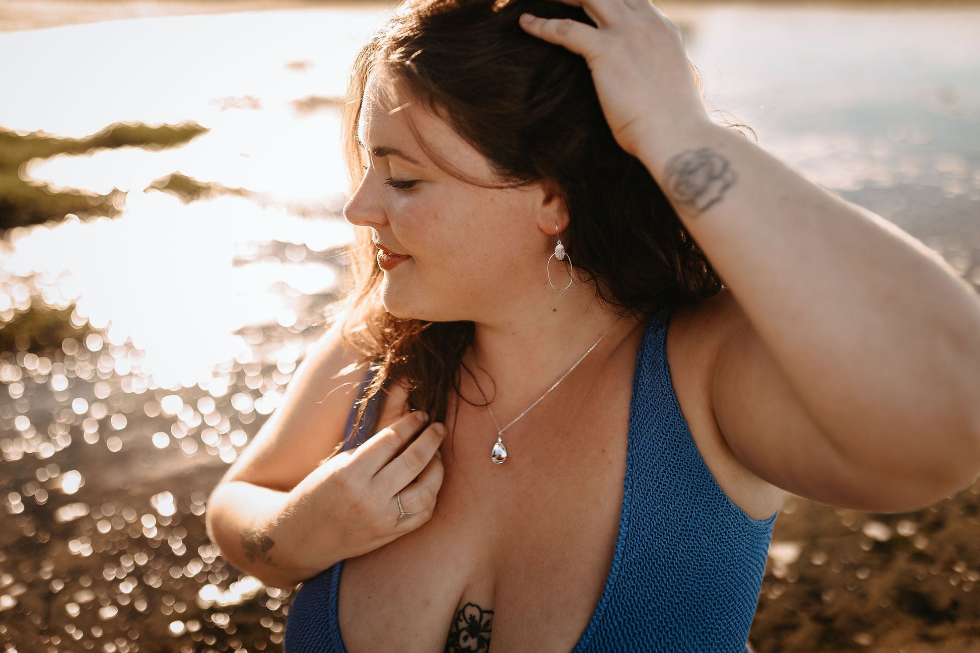 model wearing on beach the Cera Shell Textured Sterling Silver Dangle Earrings