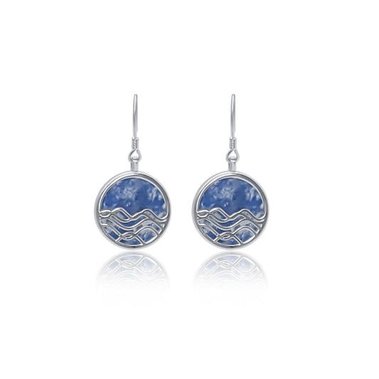 silver and blue sodalite circle earrings. ocean wave dangle earrings with blue background 