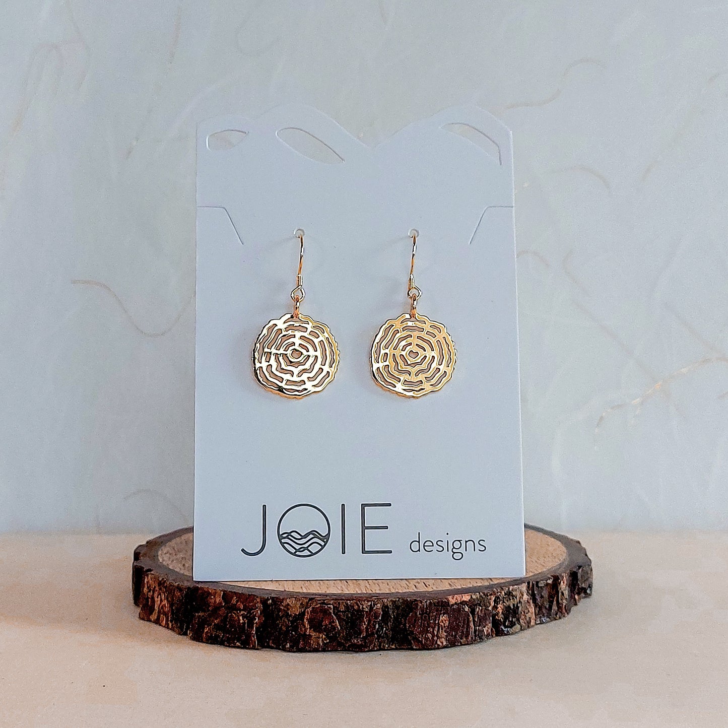18k18k yellow gold plated tree rings inspired earrings showcased on a jewellery card