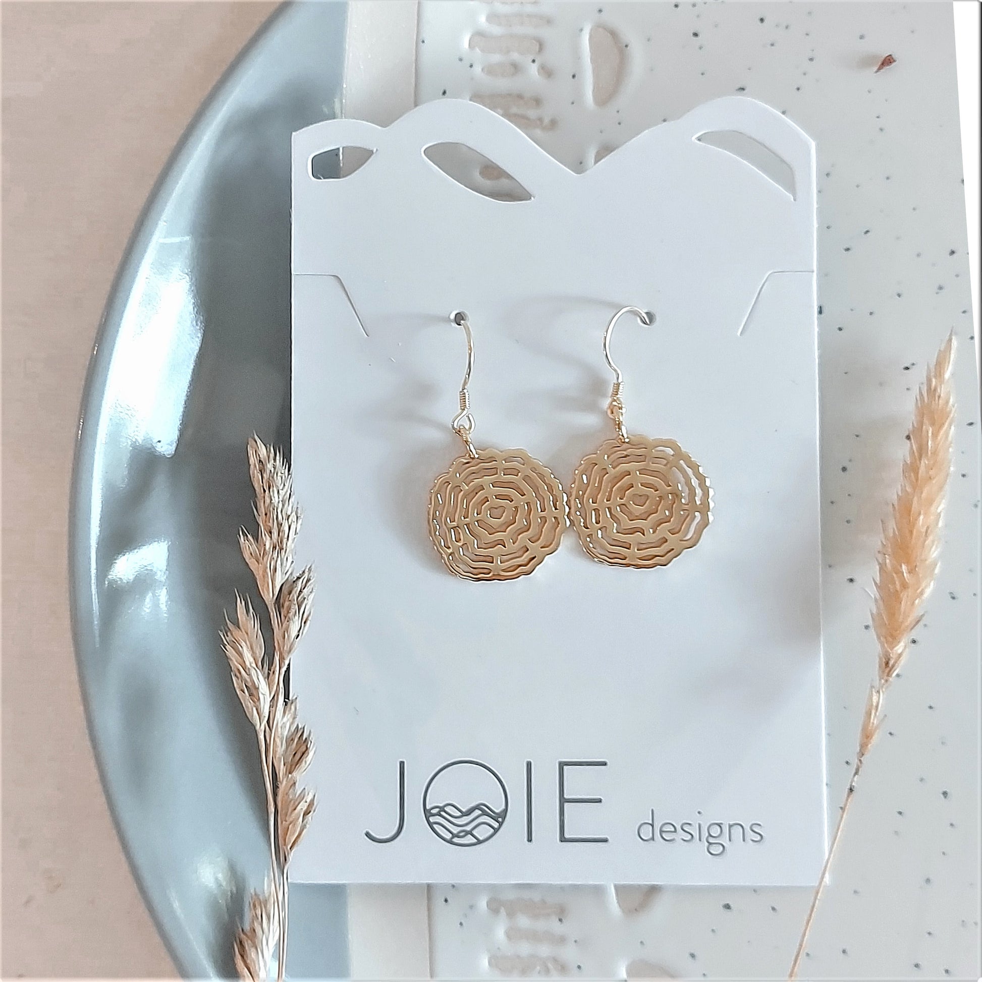 18k plated yellow gold log cross section dangle earrings on white jewelry card