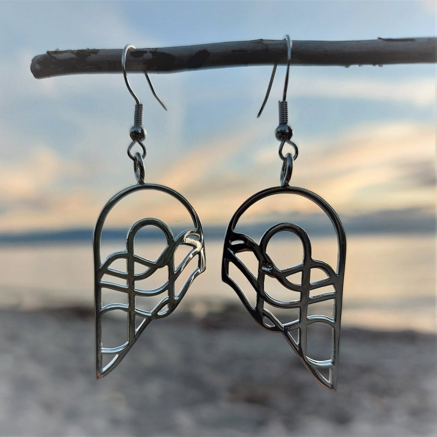 silver abstract arches that appear like wings or two half hearts. Earrings hung on french ear wires.