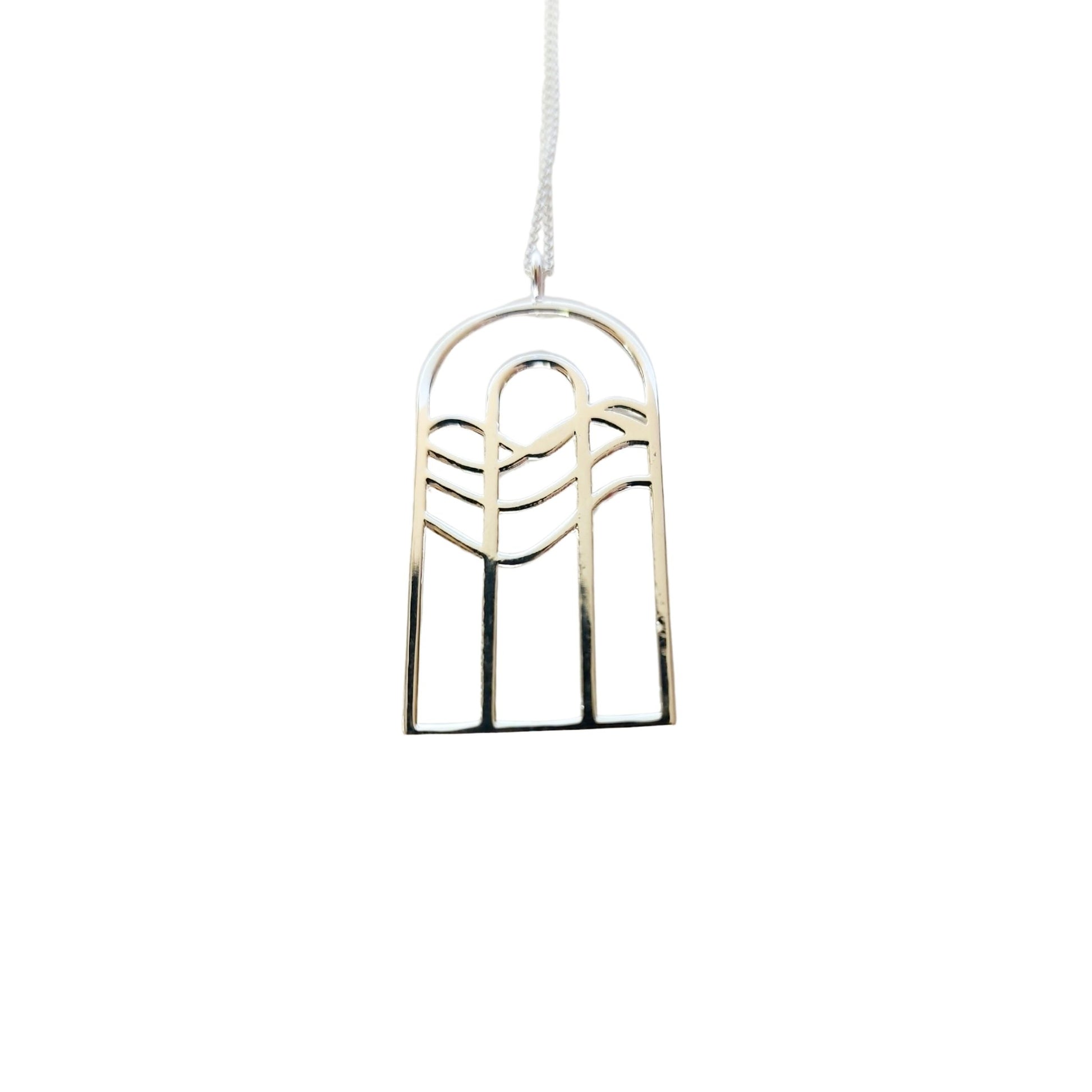 Silver necklace with rainbow water design that resembles cathedral window 2
