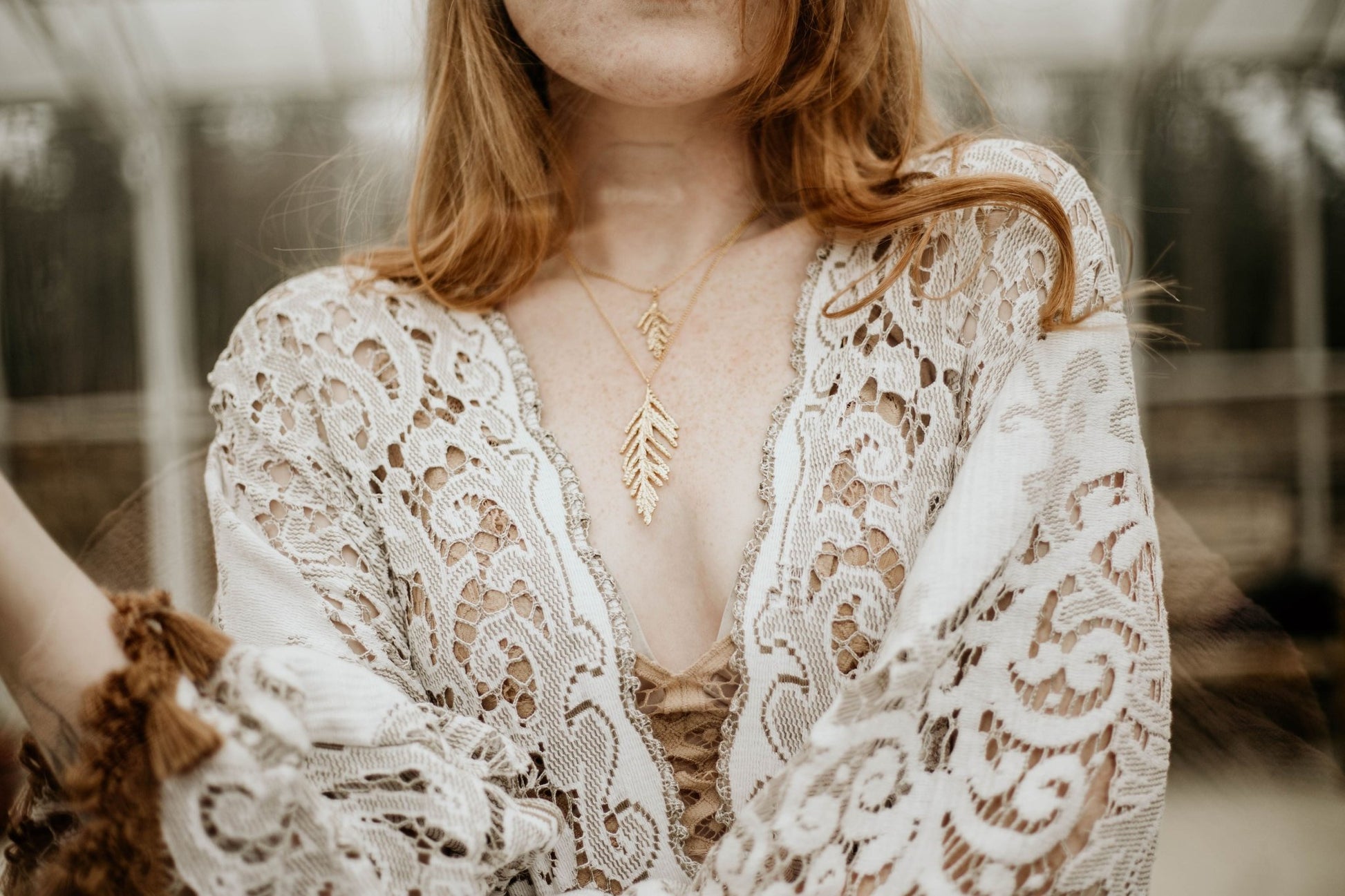 18k plated yellow gold cedar necklace on model wearing lace dress