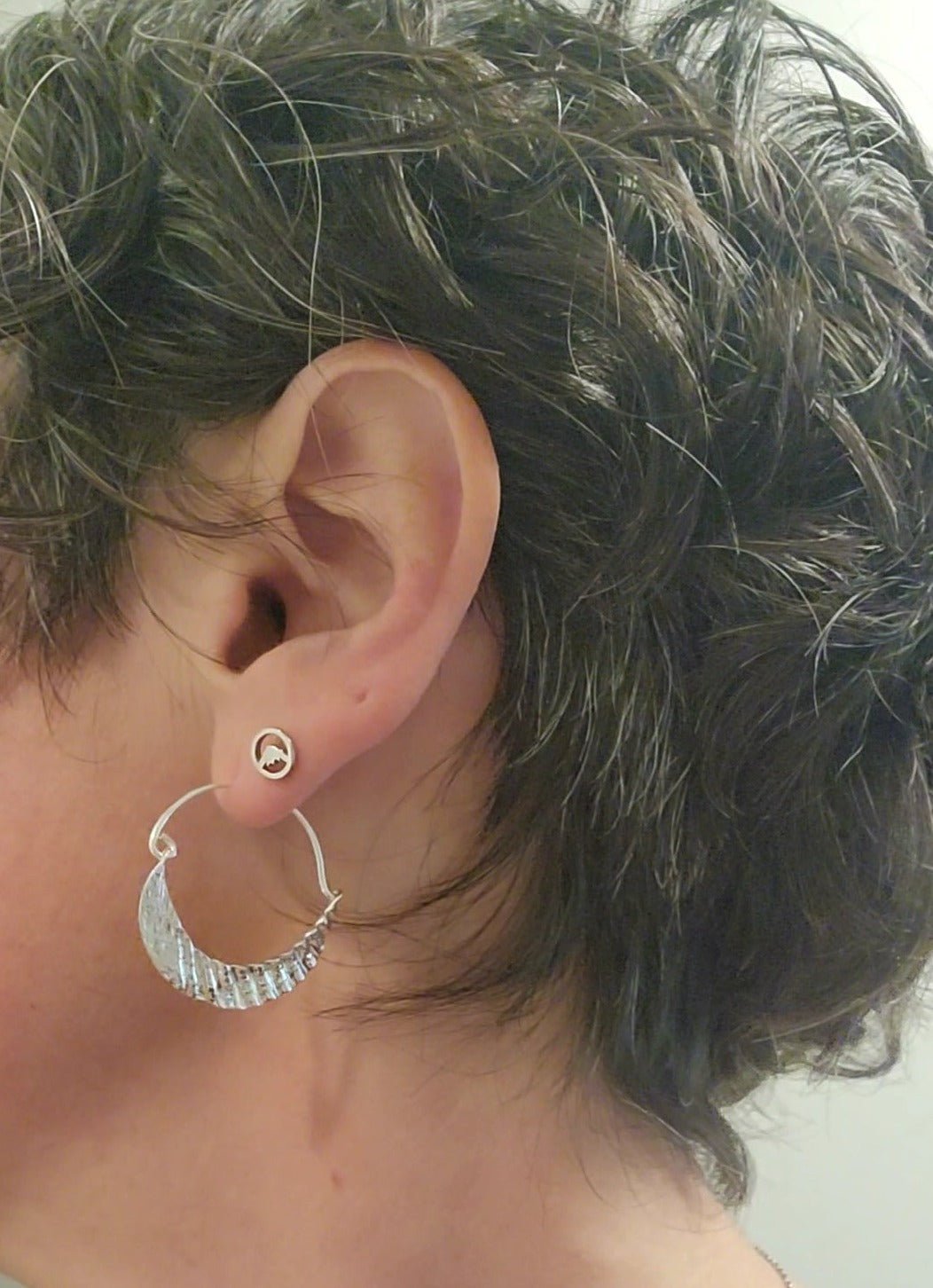 sterling silver Beaumont mountain stud earring shown with shell hoop earring