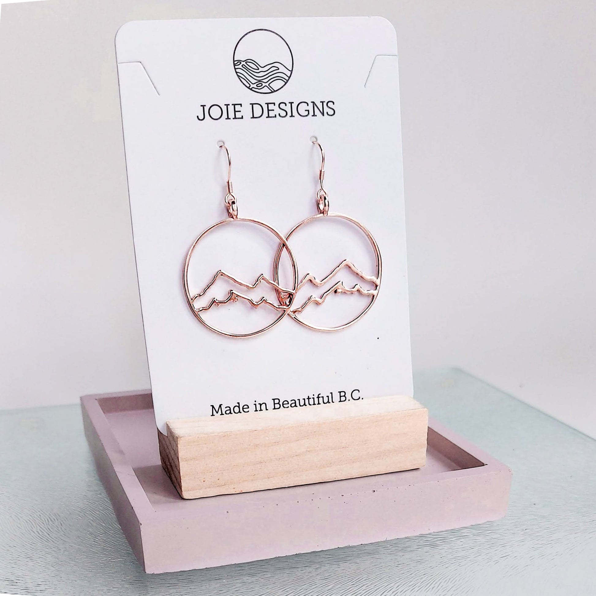circle earrings, 18k rose gold plated coastal mountain in circle design hook earring showcased on a jewelery card