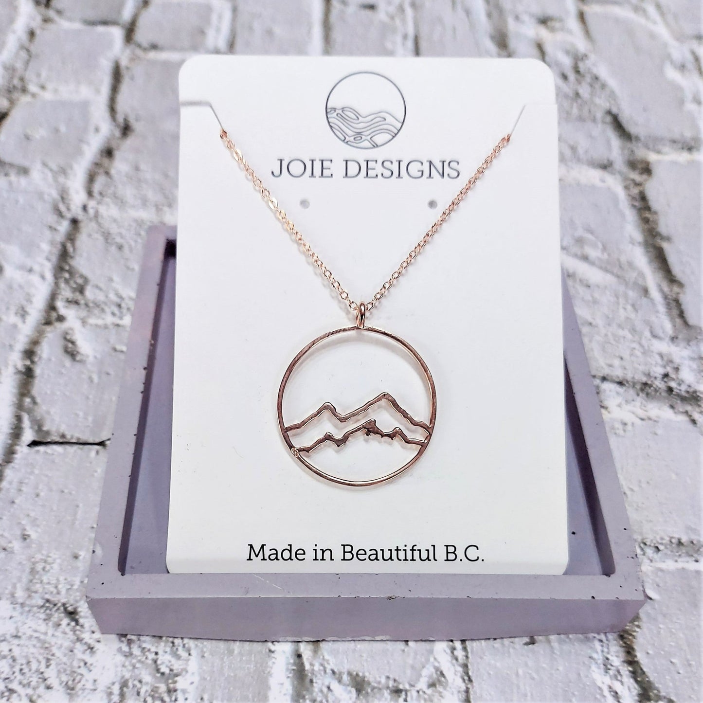 circle necklace, 18k rose gold plated coastal mountain circle pendant necklace showcased on a white jewellery card