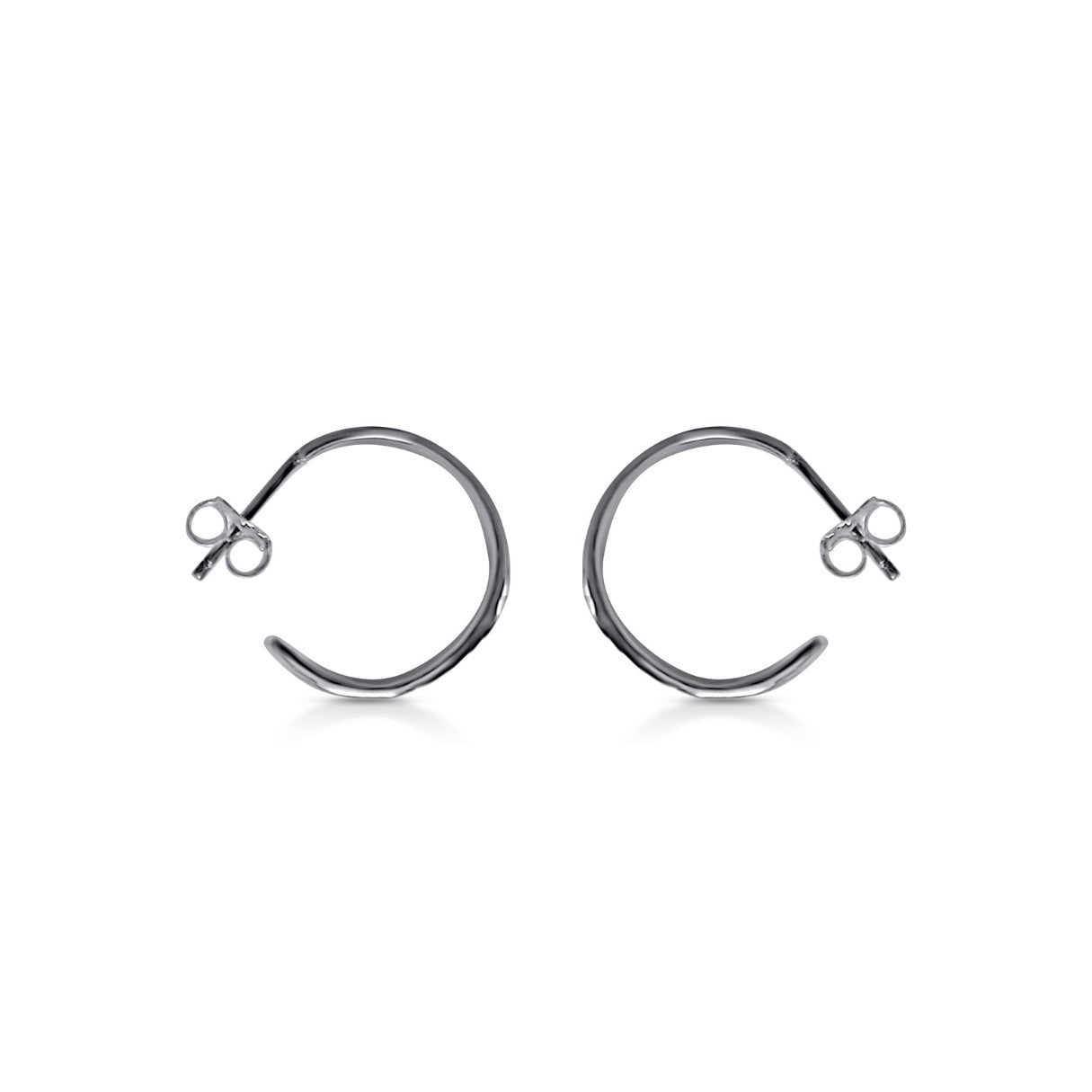 side view of organic wavy lightweight hoop earrings in tarnish resistant silver with natural wood texture