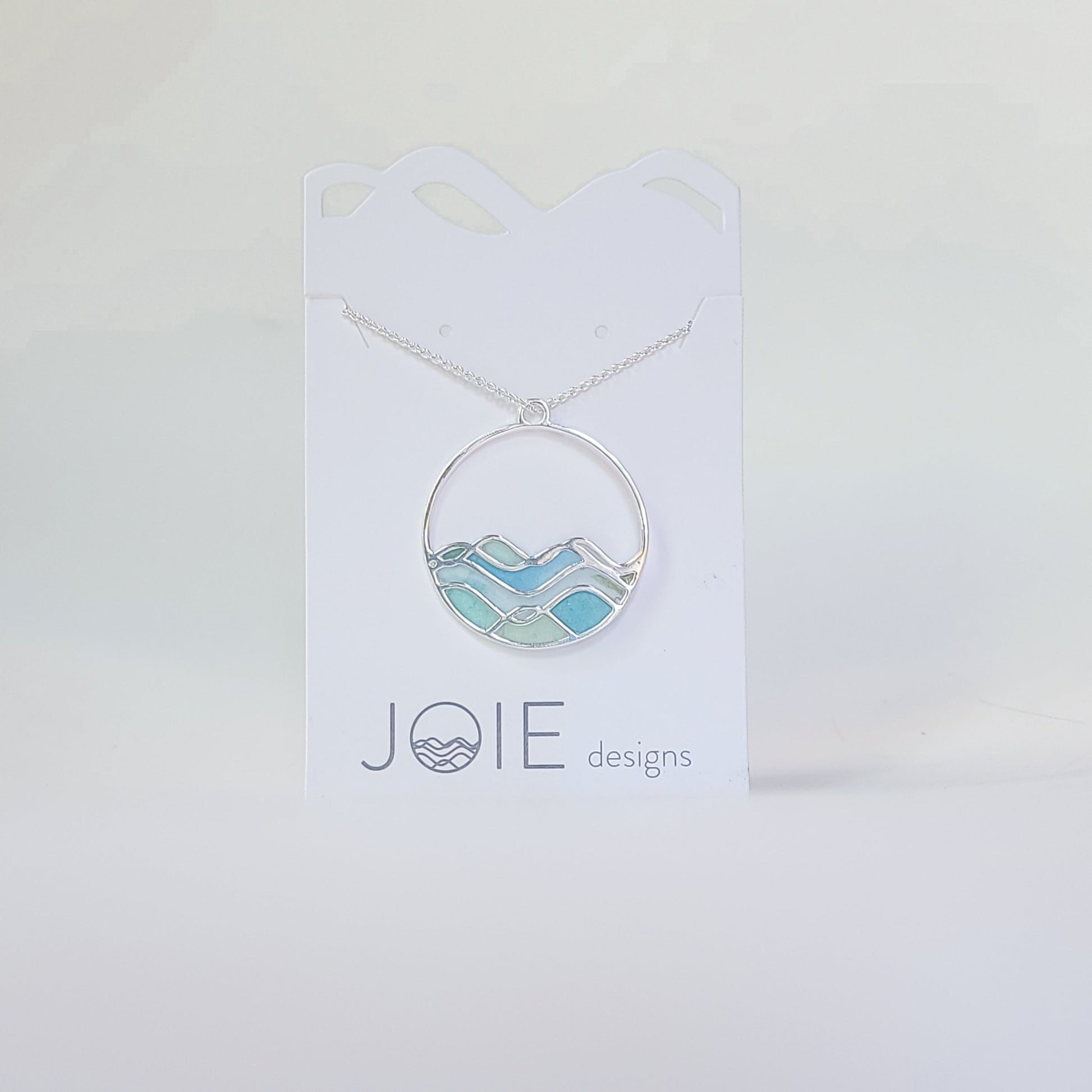 Embellsihed silver and resin blue limited edition high tide necklace side 1