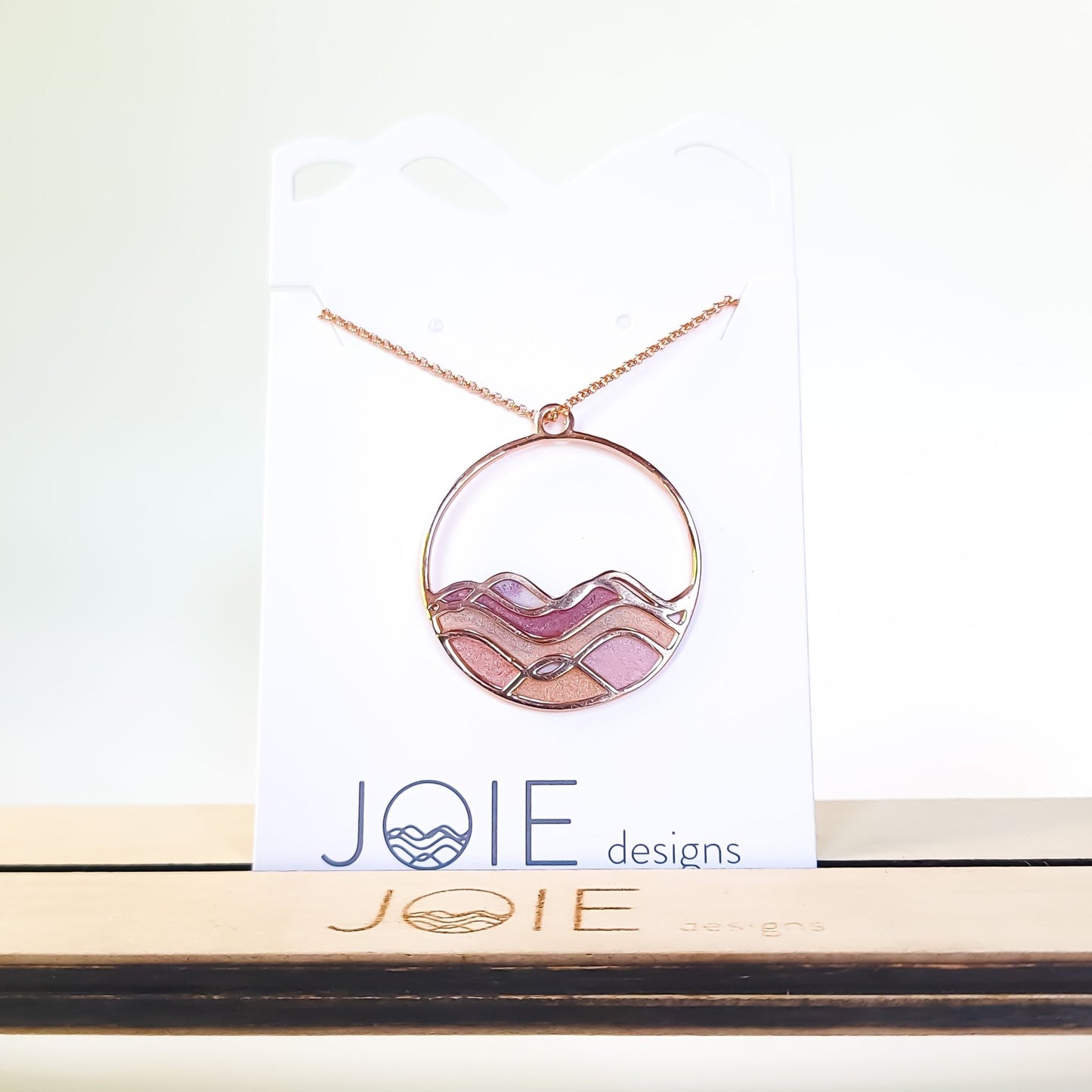 sunset colours on ocean waves rose gold pinks and gold resin in waves circle necklace