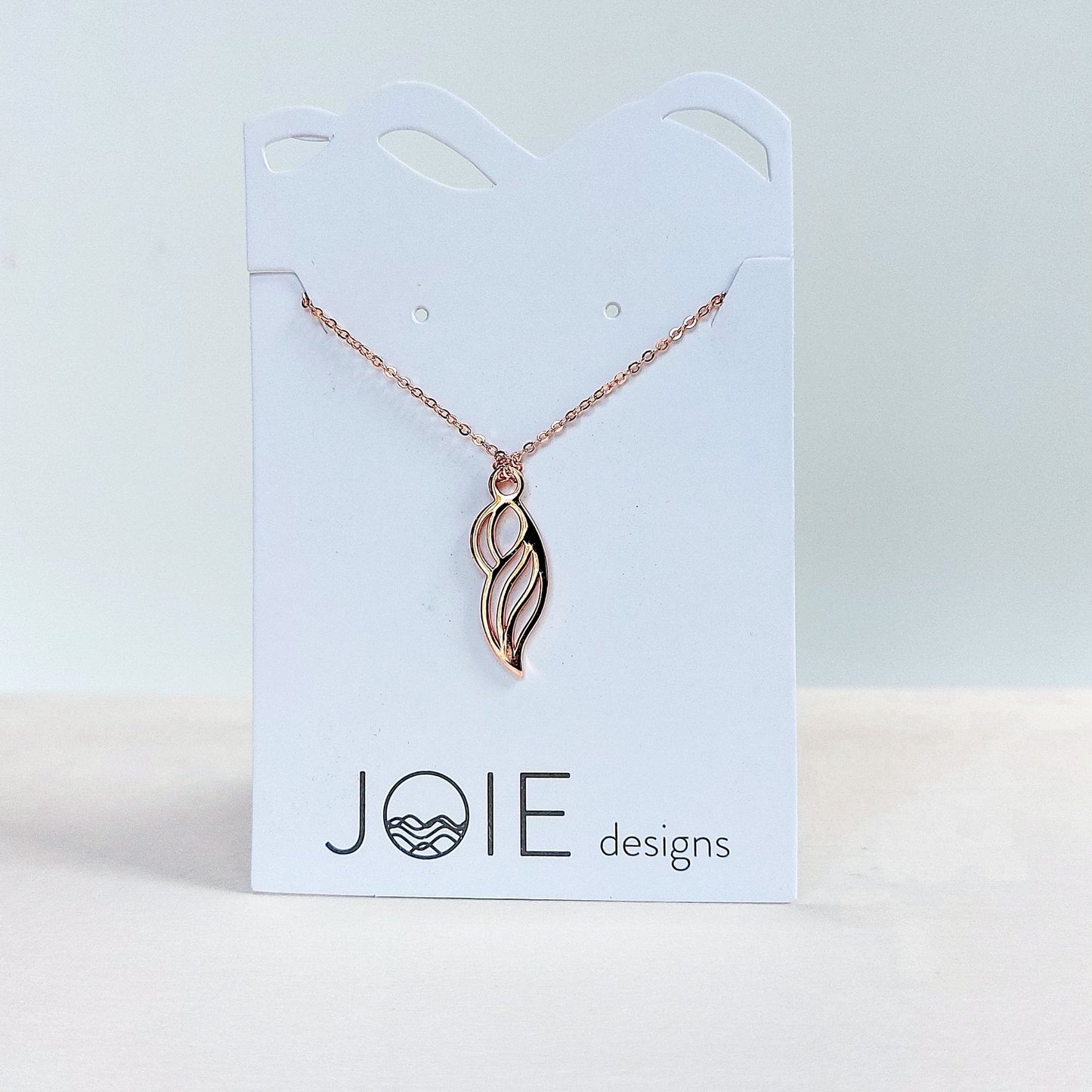 18k rose gold plated era pendant necklace that appears like a mother showcased on a jewellery card
