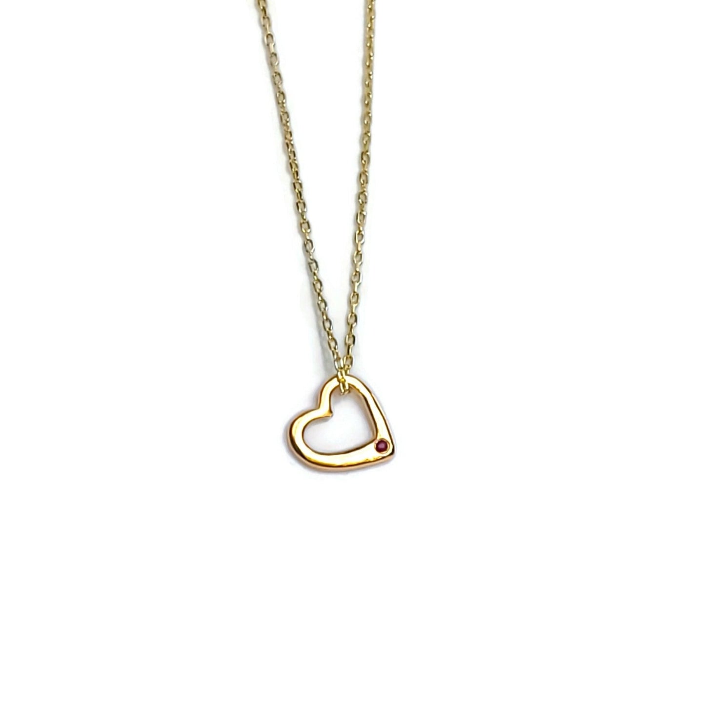 small gold heart pendant with ruby gemstone on gold necklace chain