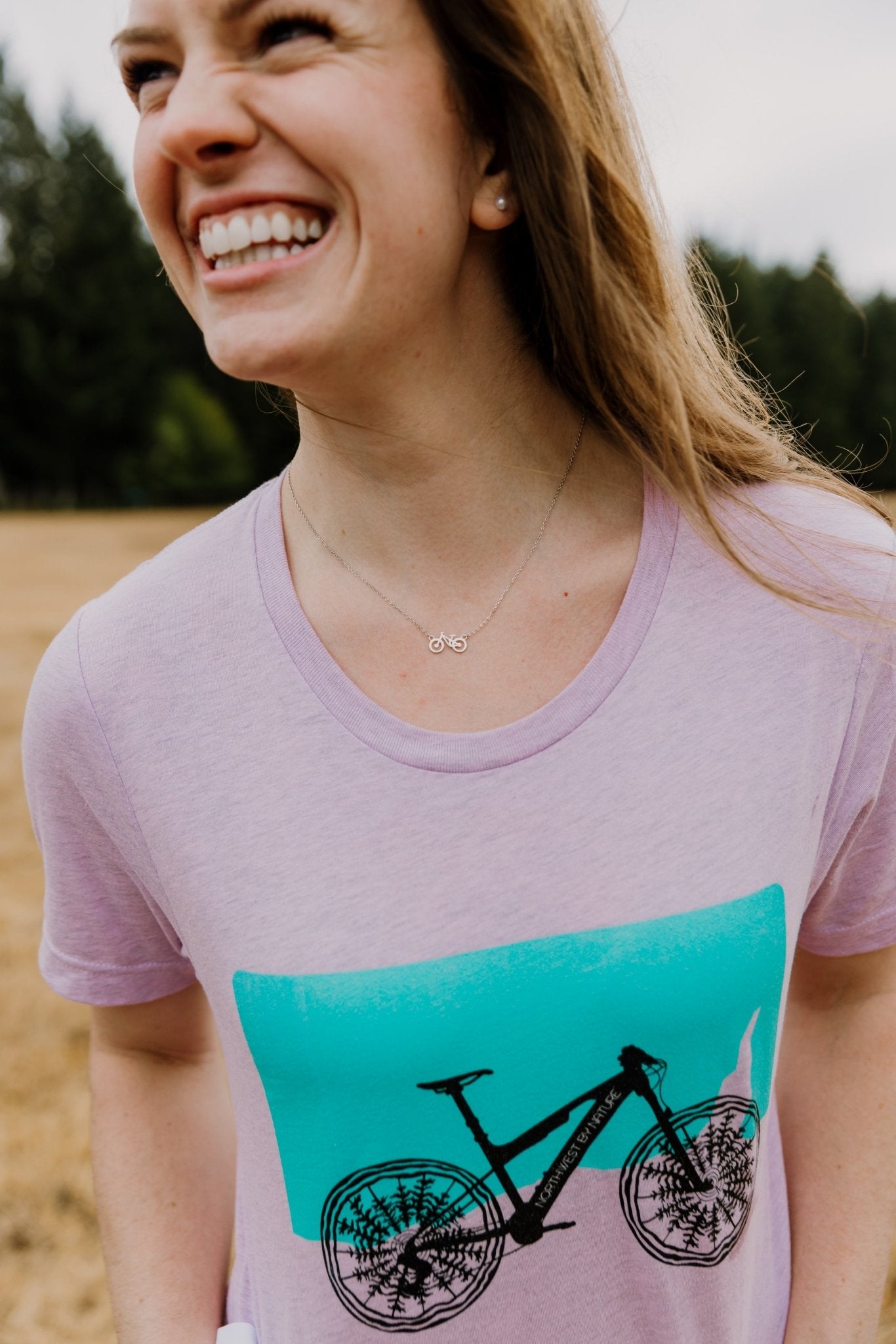 happy model wearing bike t-shirt and silver bike necklace
