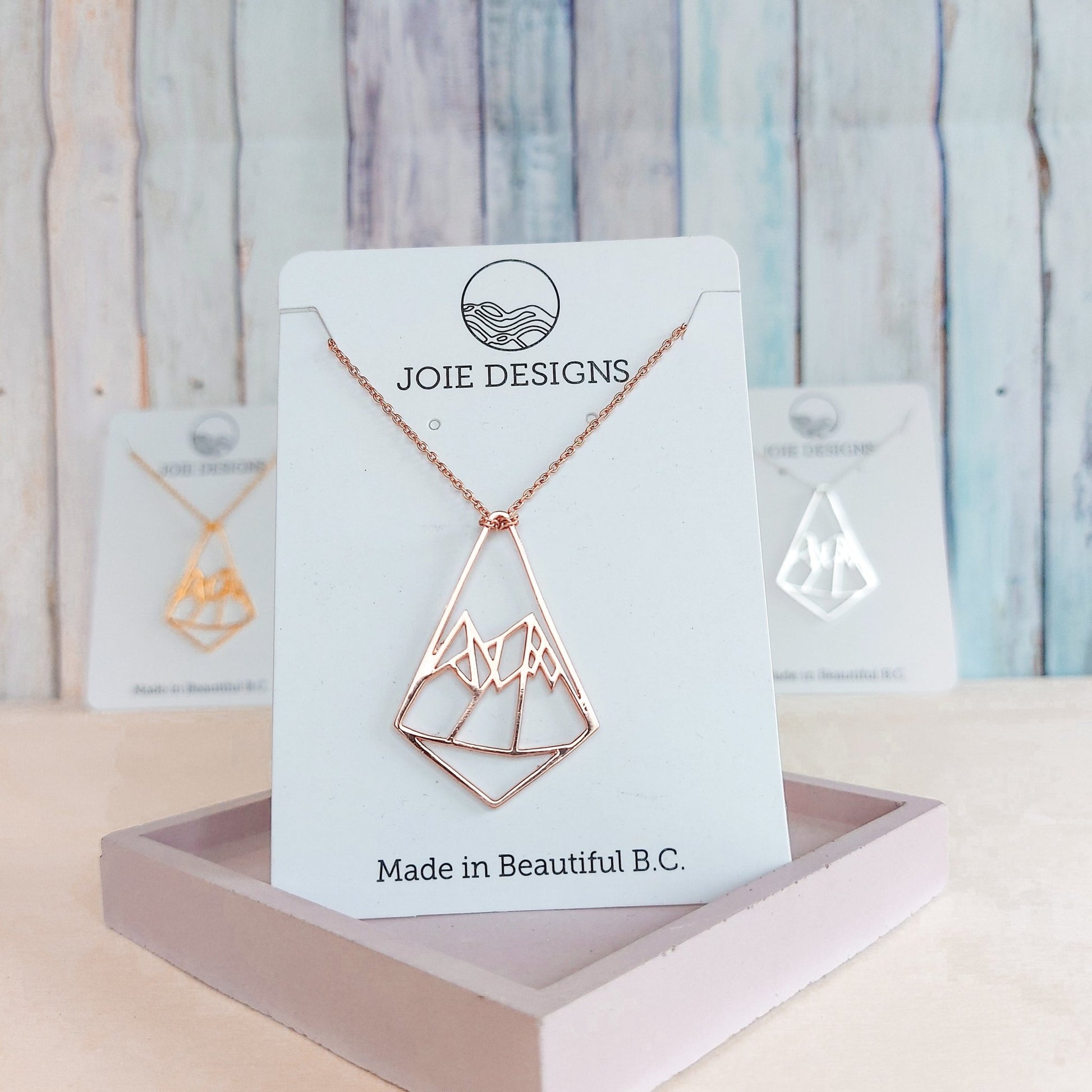 18k rose gold plated geo mountain design pendant necklace showcased on a jewelry card