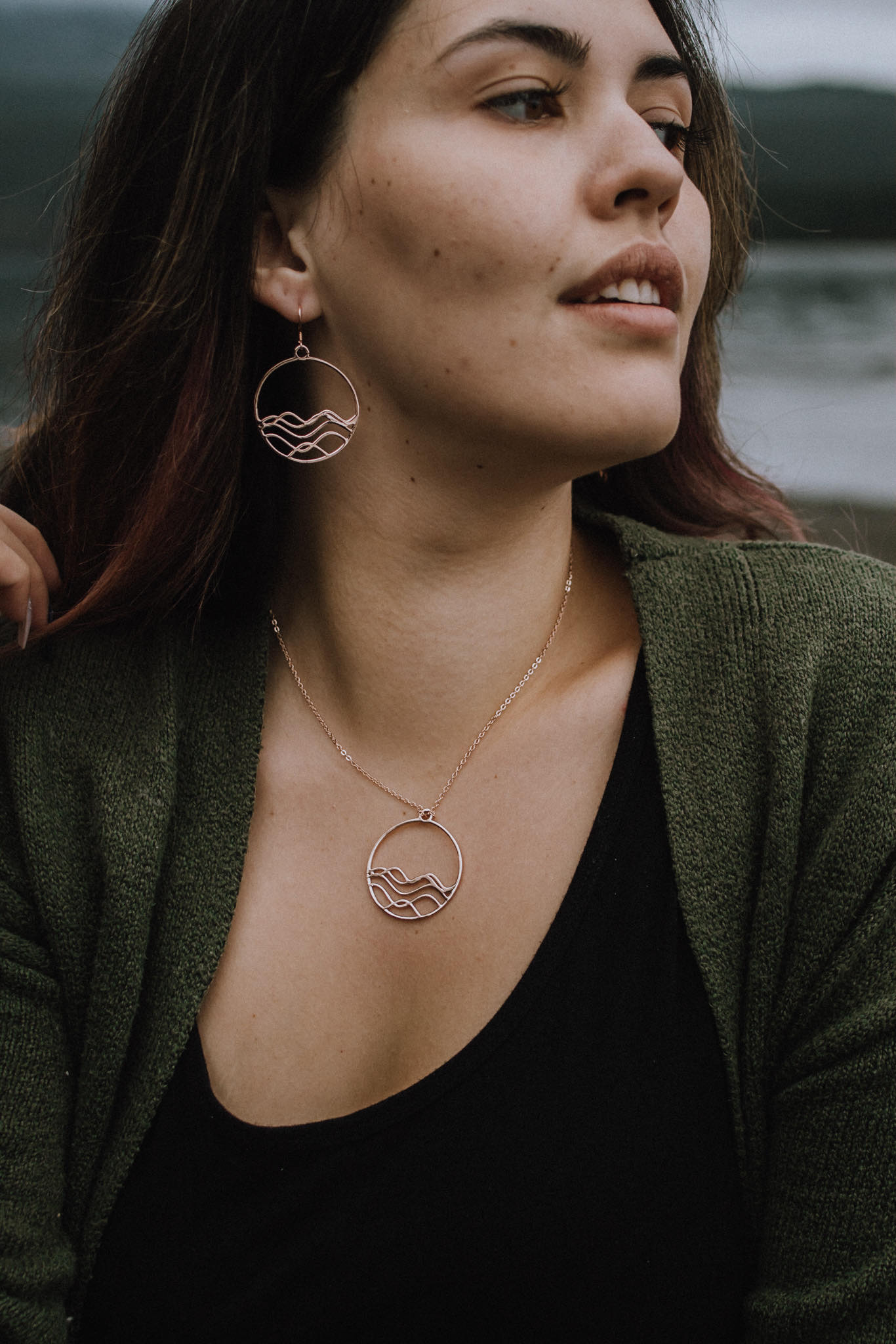 Model showing 18k plated rose gold high tide circle earrings and necklace