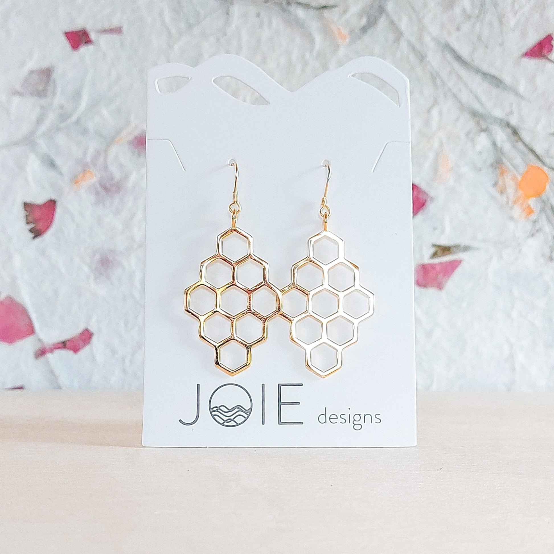 18k plated yellow gold plate diamond-shaped honeycomb  drop earrings shown on jewelry card with wildflower paper background